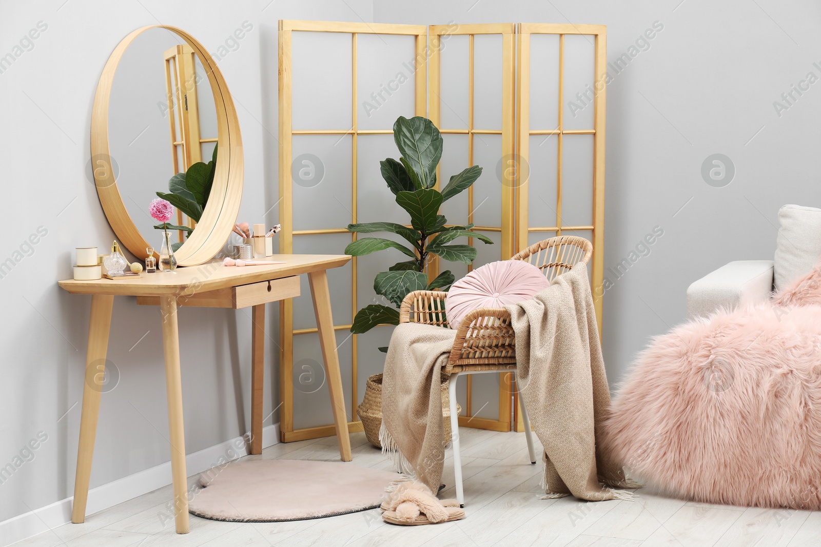 Photo of Mirror, dressing table, houseplant, folding screen and chair indoors. Interior design