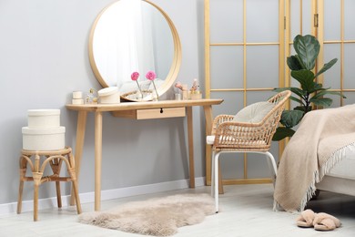 Photo of Mirror, dressing table, houseplant, folding screen and chair indoors. Interior design