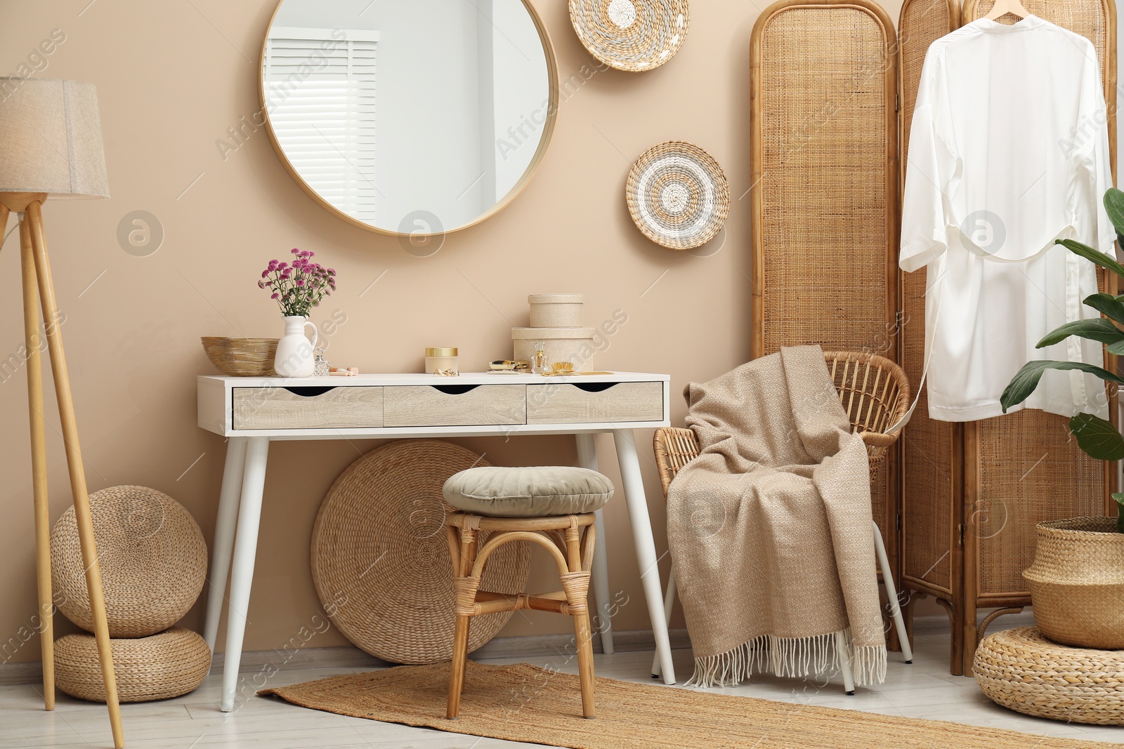 Photo of Stylish dressing table with mirror in room