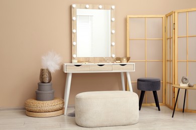 Photo of Stylish dressing table with mirror in room