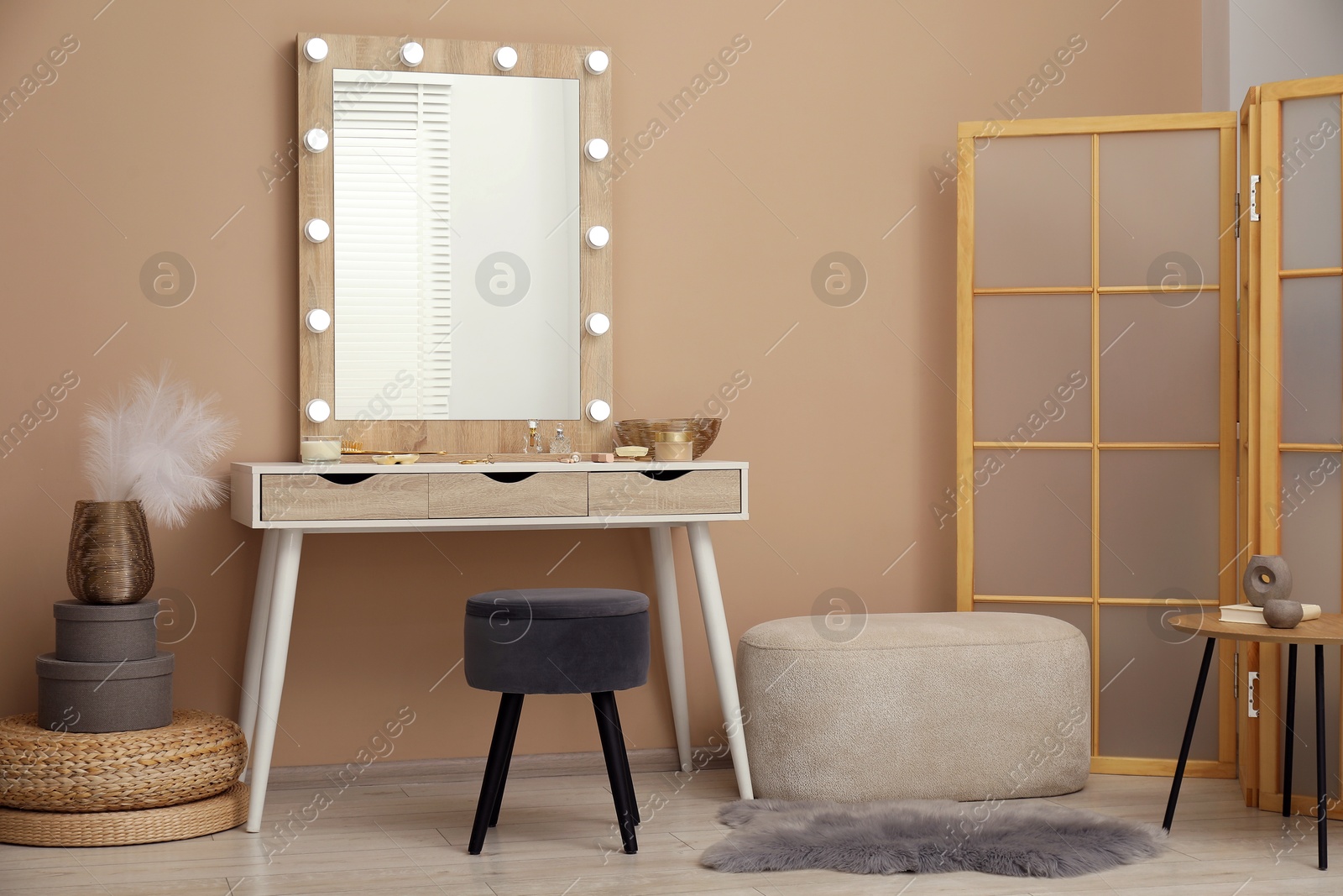 Photo of Stylish dressing table with mirror in room