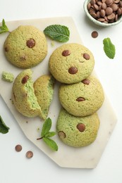 Photo of Delicious mint chocolate chip cookies on white table, flat lay