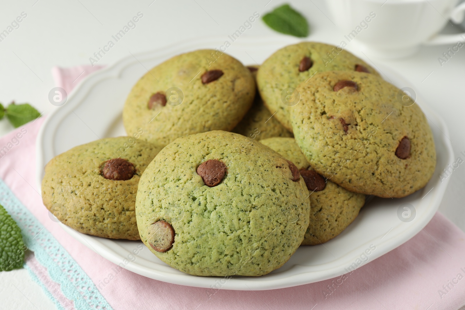 Photo of Delicious mint chocolate chip cookies on table, closeup