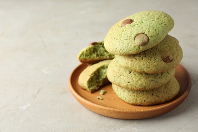 Photo of Delicious mint chocolate chip cookies on light table, closeup. Space for text