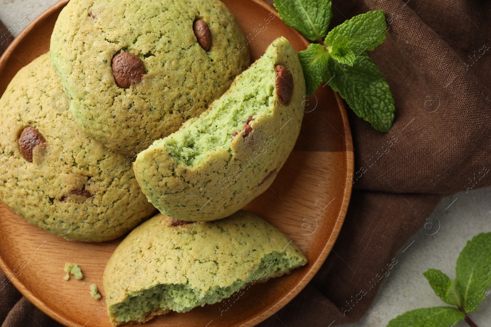 Photo of Delicious mint chocolate chip cookies on light table, top view