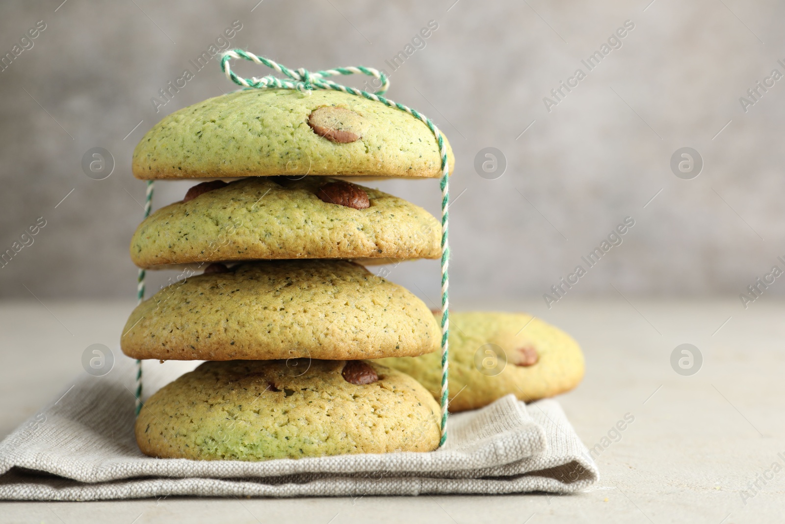 Photo of Delicious mint chocolate chip cookies on light table, closeup. Space for text