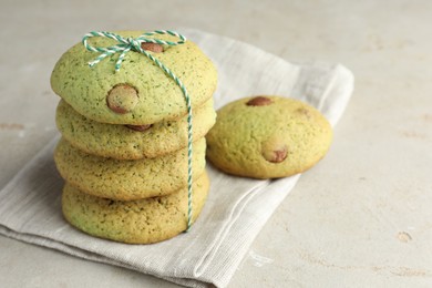 Photo of Delicious mint chocolate chip cookies on light table, closeup. Space for text