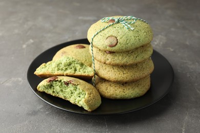 Photo of Delicious mint chocolate chip cookies on grey table, closeup