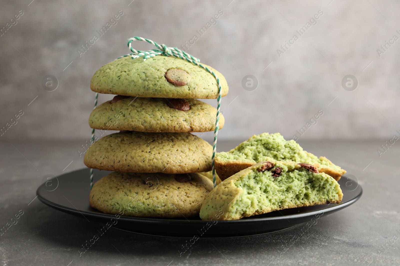 Photo of Delicious mint chocolate chip cookies on grey table, closeup