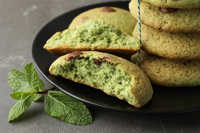 Photo of Delicious mint chocolate chip cookies on grey table, closeup