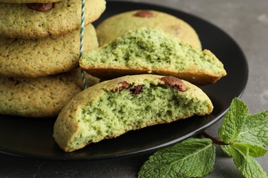 Photo of Delicious mint chocolate chip cookies on grey table, closeup