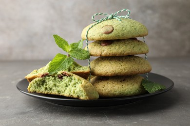 Photo of Delicious mint chocolate chip cookies on grey table, closeup