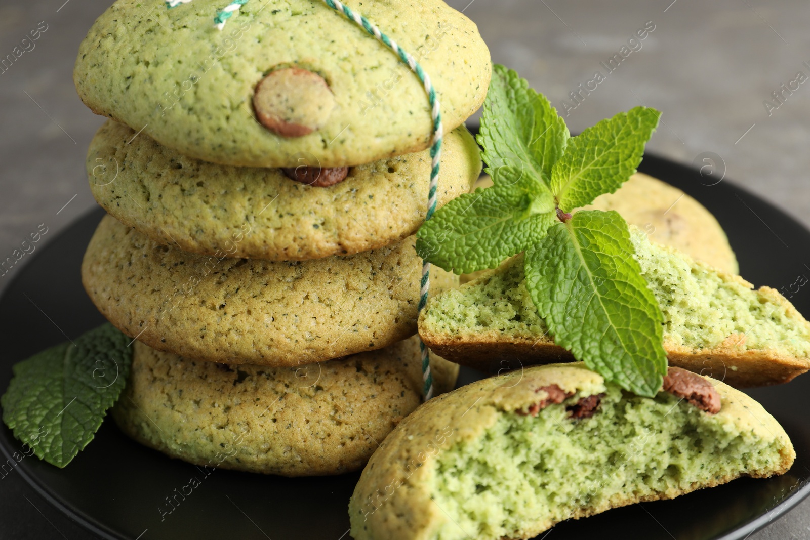 Photo of Delicious mint chocolate chip cookies on grey table, closeup