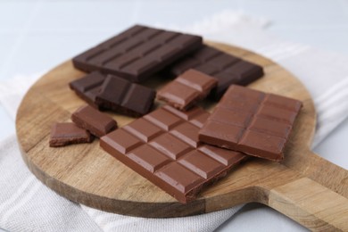 Photo of Different types of chocolate on light table, closeup