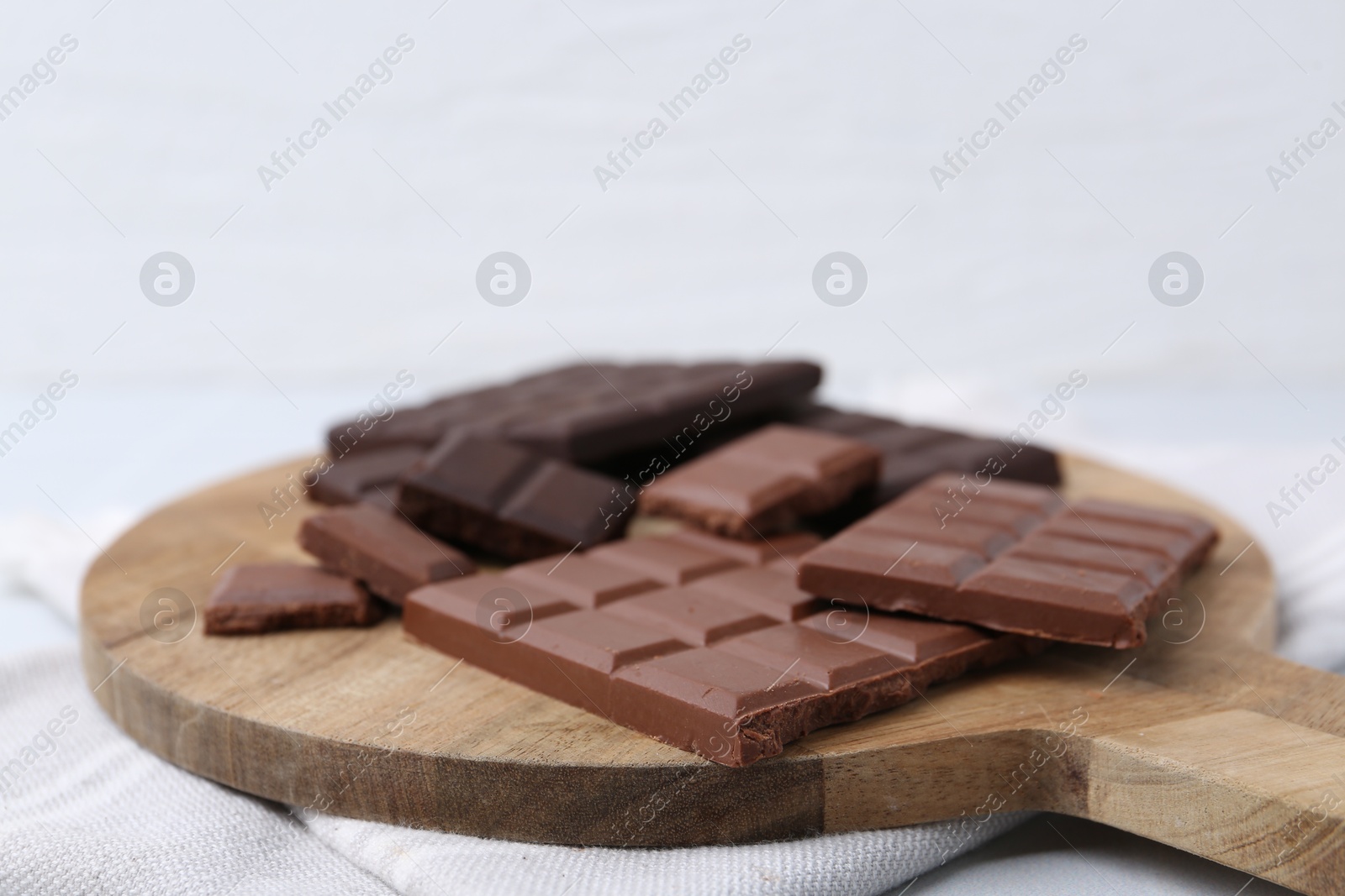 Photo of Different types of chocolate on light table, closeup