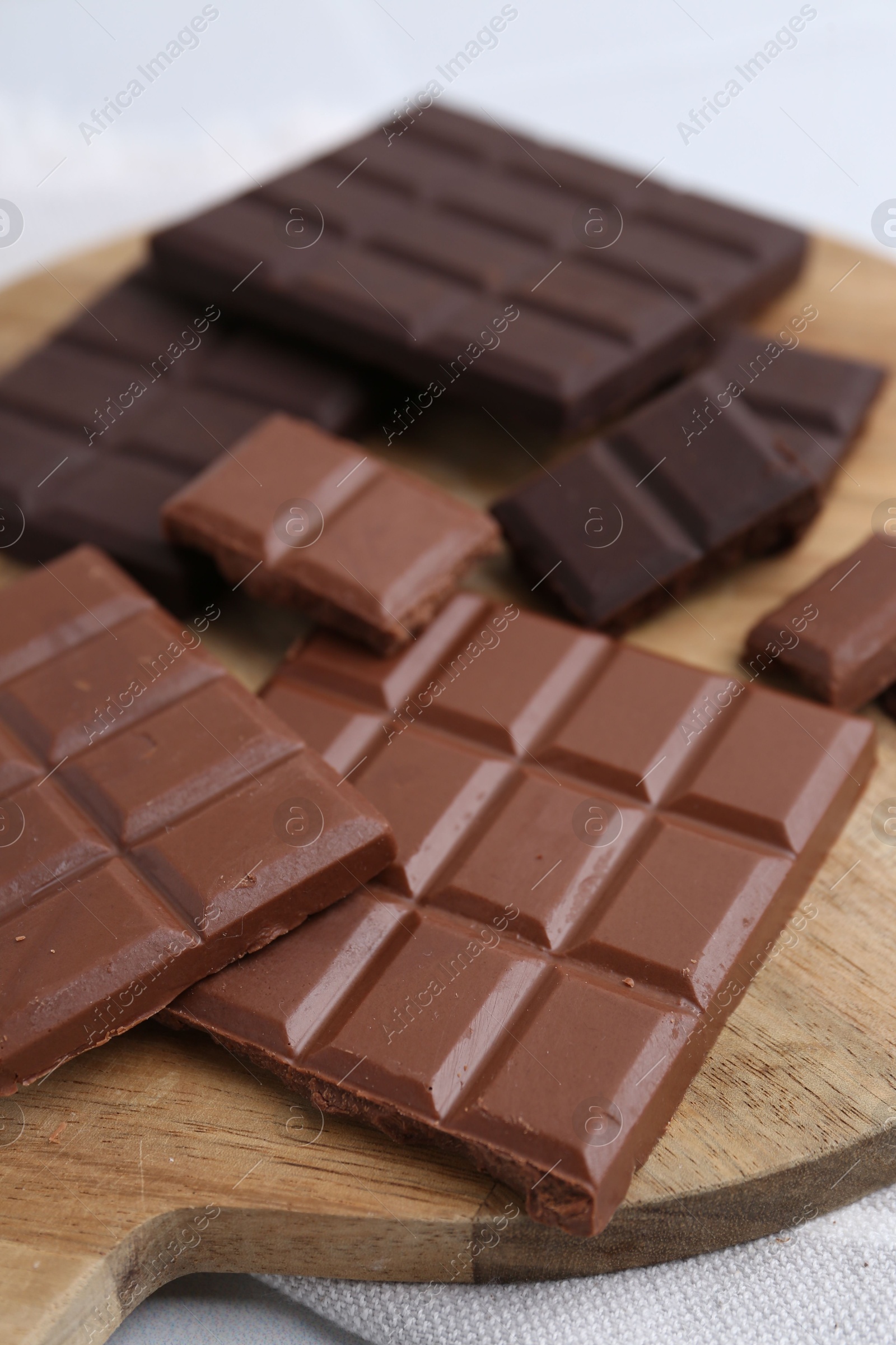 Photo of Different types of chocolate on light table, closeup