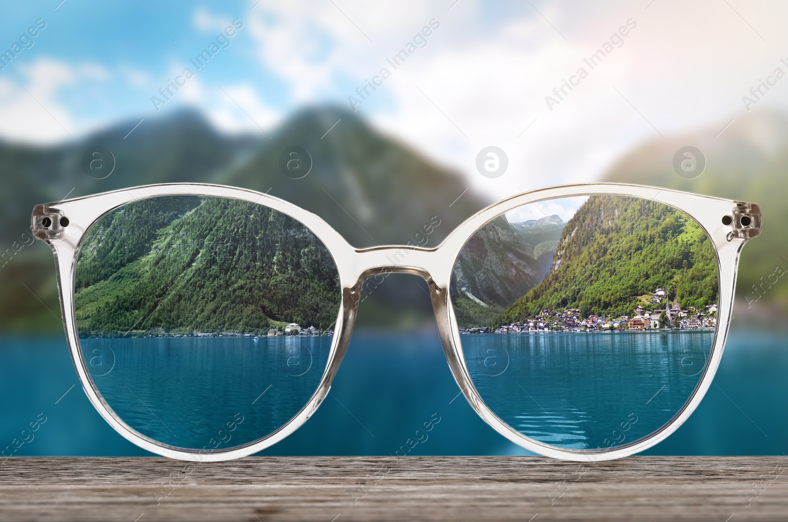 Image of Glasses against beautiful landscape. View through lenses more clear. Vision correction