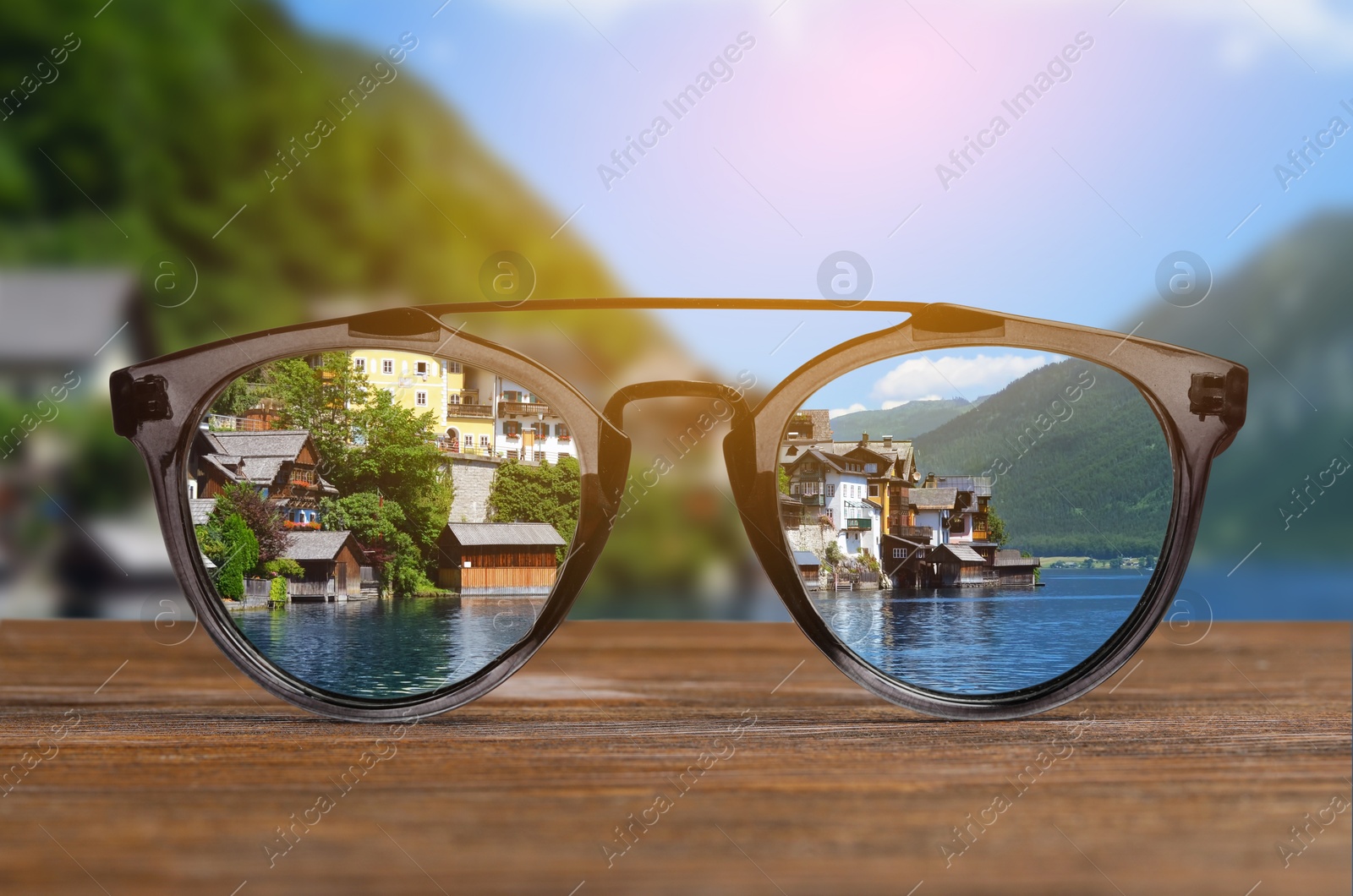 Image of Glasses against beautiful landscape. View through lenses more clear. Vision correction