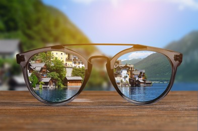 Image of Glasses against beautiful landscape. View through lenses more clear. Vision correction