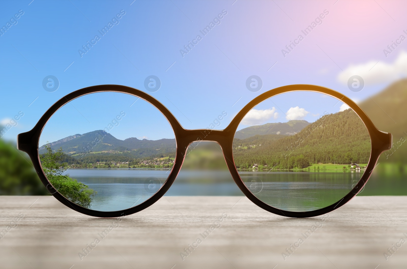 Image of Glasses against beautiful landscape. View through lenses more clear. Vision correction