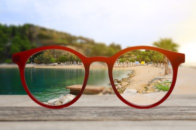 Image of Glasses against beautiful landscape. View through lenses more clear. Vision correction