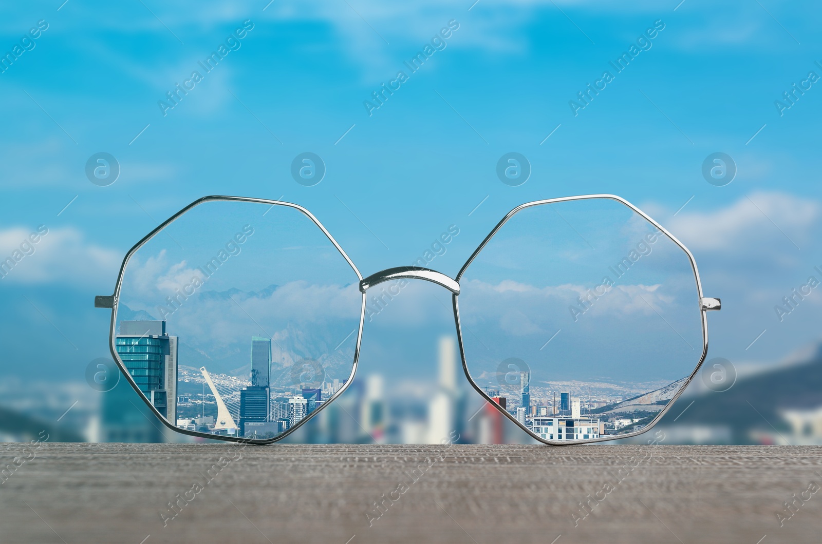 Image of Glasses against cityscape. View through lenses more clear. Vision correction