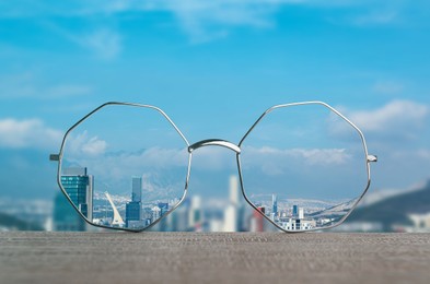 Image of Glasses against cityscape. View through lenses more clear. Vision correction