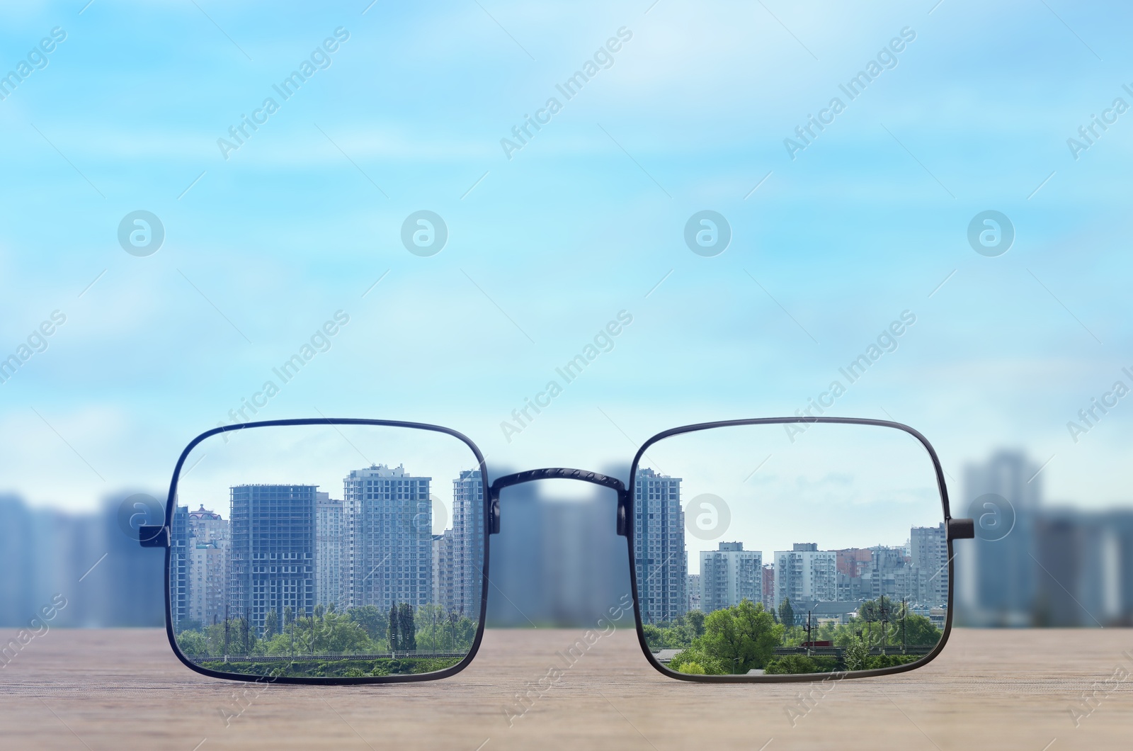 Image of Glasses against cityscape. View through lenses more clear. Vision correction