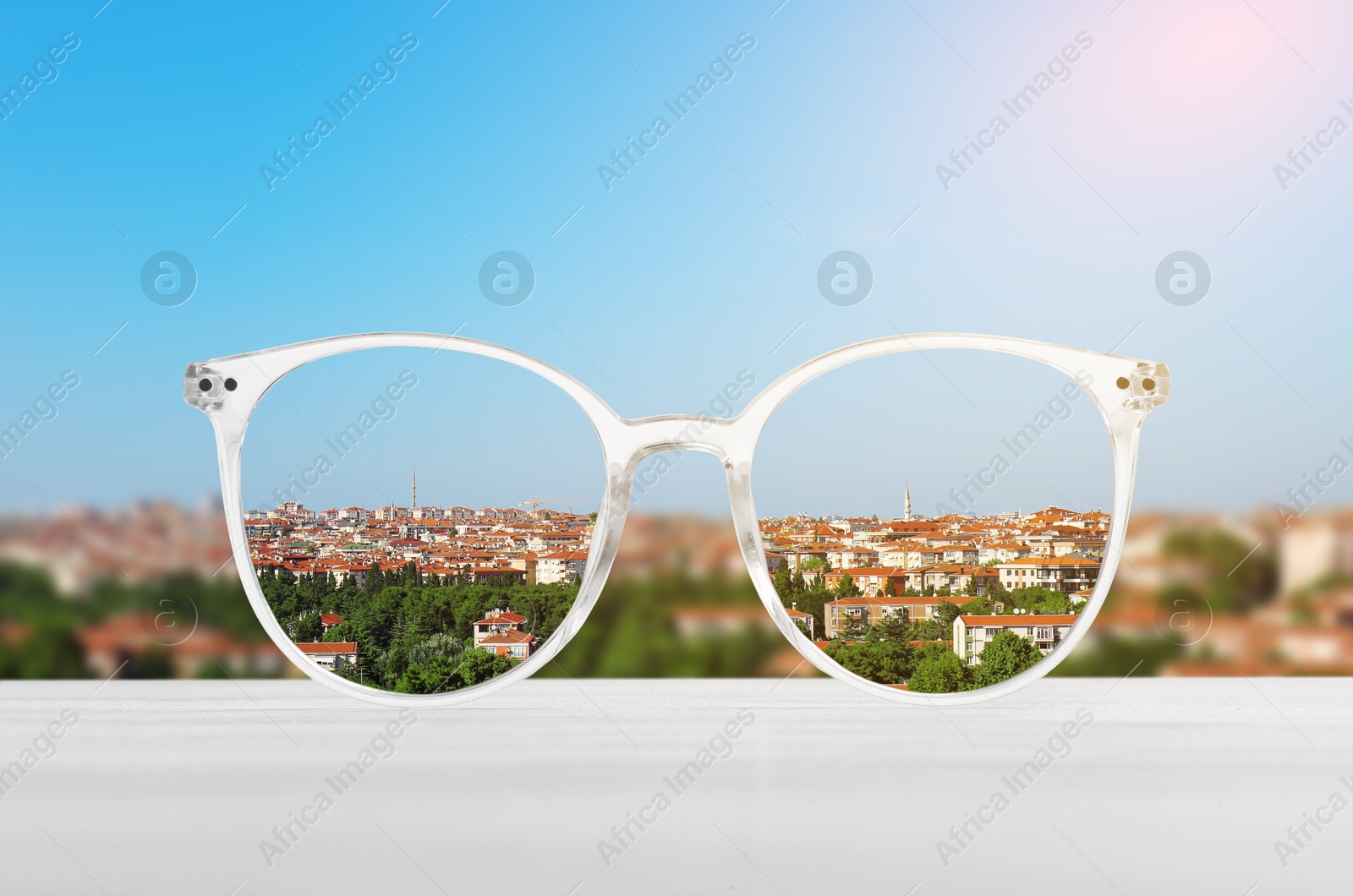 Image of Glasses against cityscape. View through lenses more clear. Vision correction