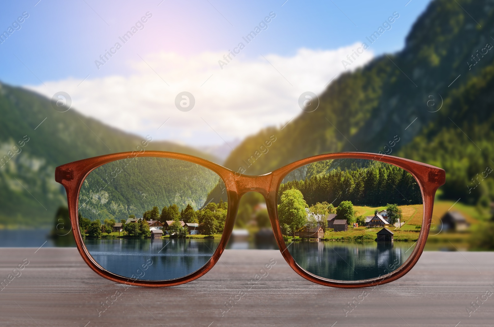 Image of Glasses against beautiful landscape. View through lenses more clear. Vision correction