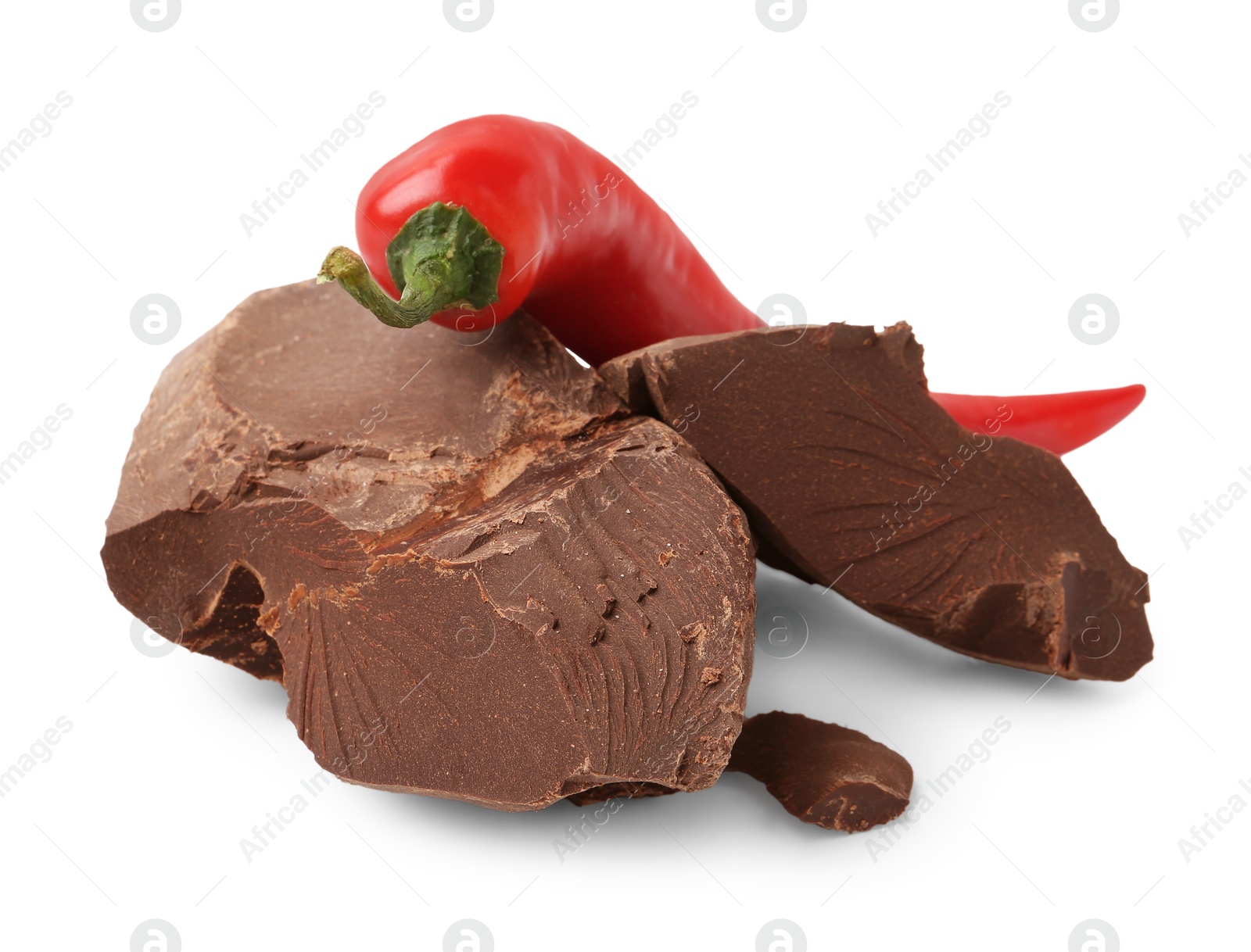 Photo of Pieces of tasty chocolate with chili pepper isolated on white