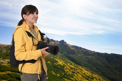 Image of Photographer with camera and backpack in mountains