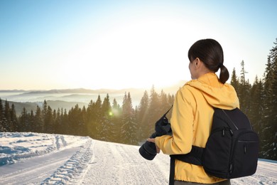 Image of Photographer with camera and backpack in mountains