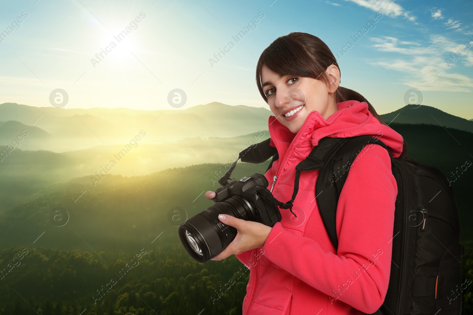 Image of Photographer with camera and backpack in mountains