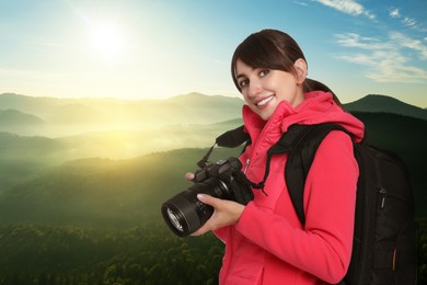 Image of Photographer with camera and backpack in mountains