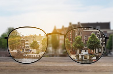 Image of Glasses against cityscape. View through lenses more clear. Vision correction