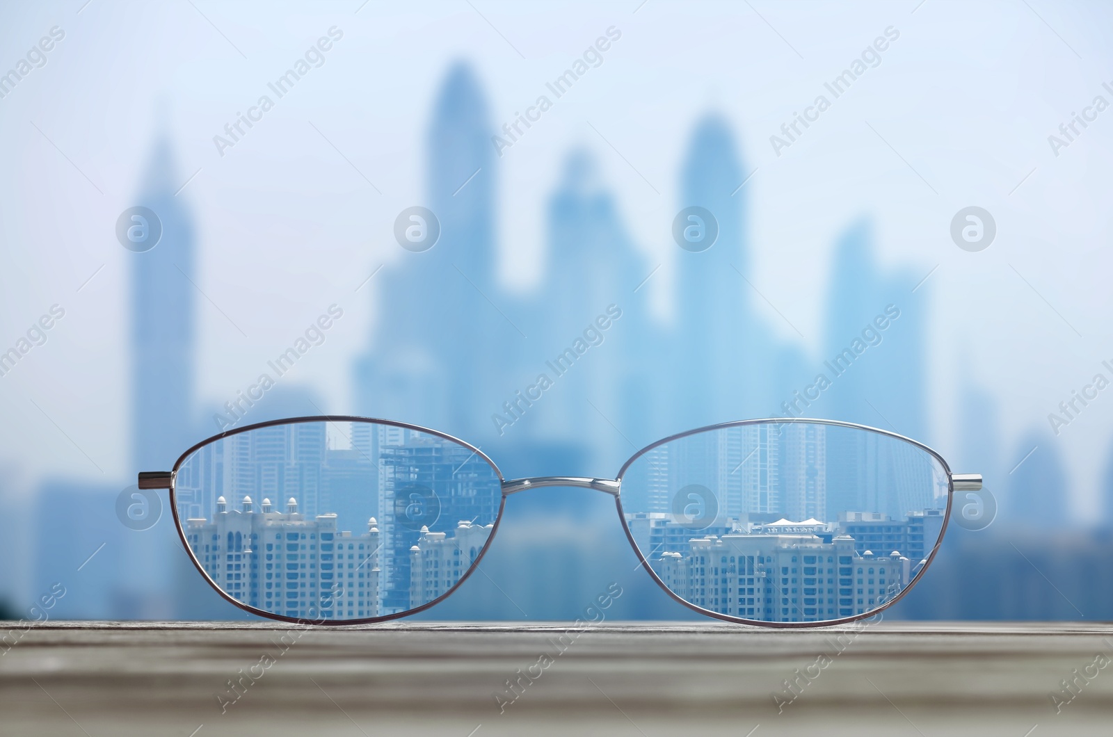 Image of Glasses against cityscape. View through lenses more clear. Vision correction