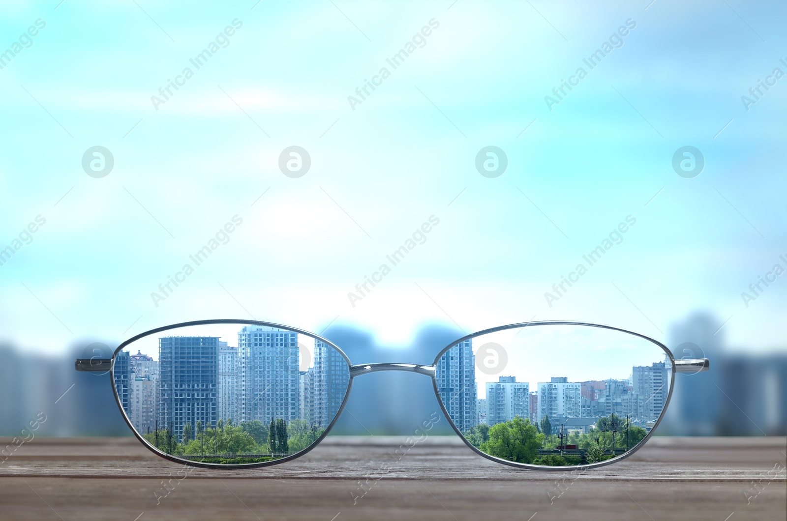 Image of Glasses against cityscape. View through lenses more clear. Vision correction