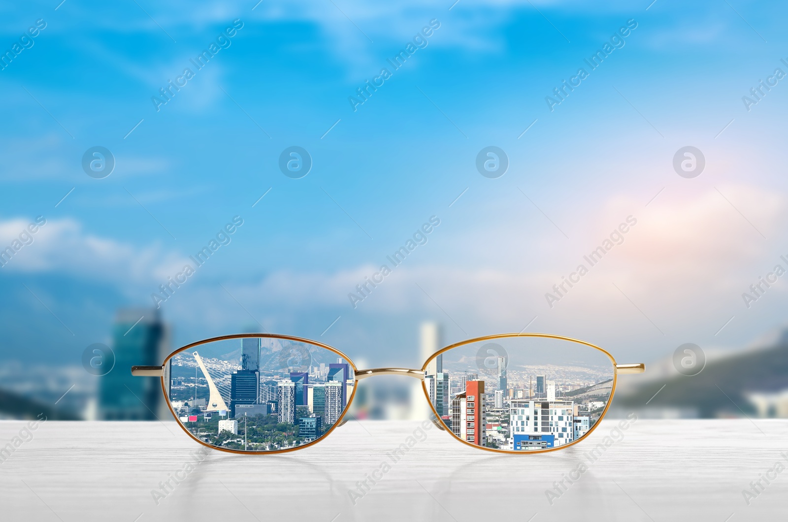 Image of Glasses against cityscape. View through lenses more clear. Vision correction