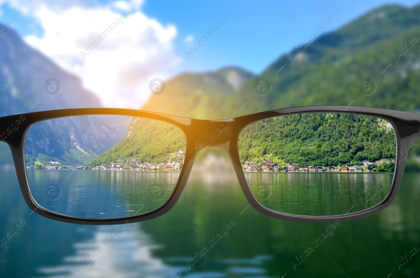 Image of Glasses against beautiful landscape. View through lenses more clear. Vision correction