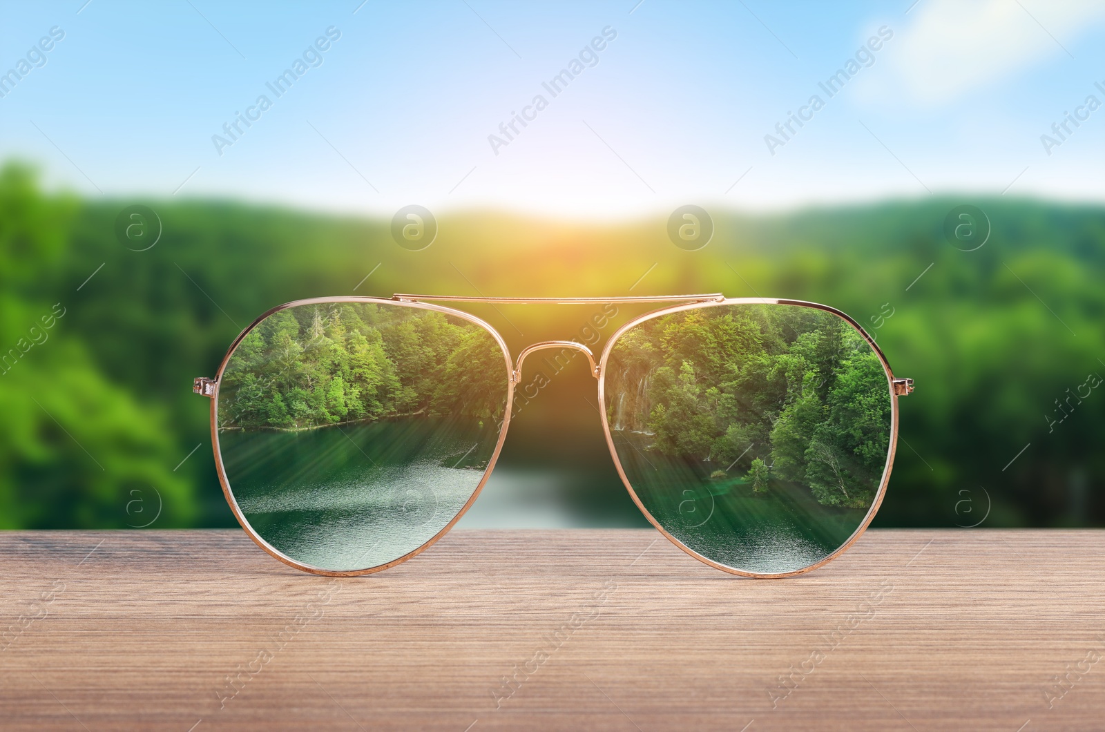 Image of Glasses against beautiful landscape. View through lenses more clear. Vision correction