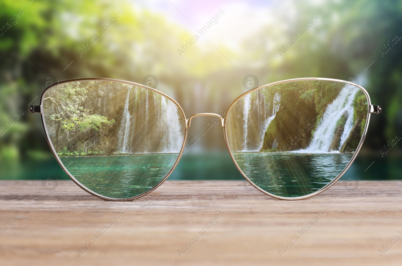 Image of Glasses against beautiful landscape. View through lenses more clear. Vision correction