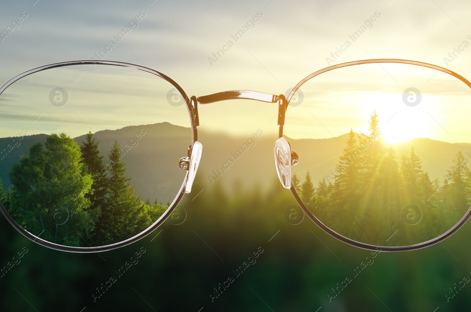 Image of Glasses against beautiful mountain landscape. View through lenses more clear. Vision correction