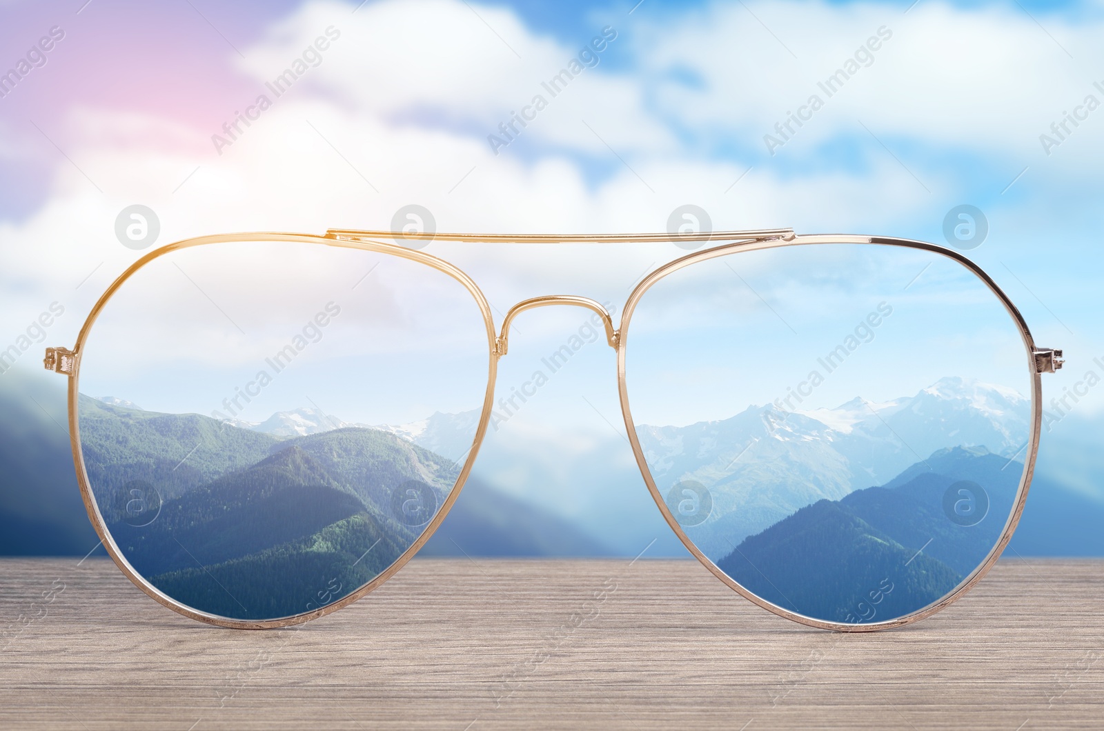 Image of Glasses against beautiful mountain landscape. View through lenses more clear. Vision correction