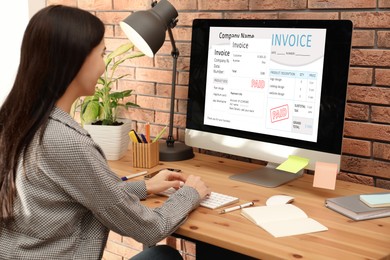 Image of Woman using computer to pay bills at home