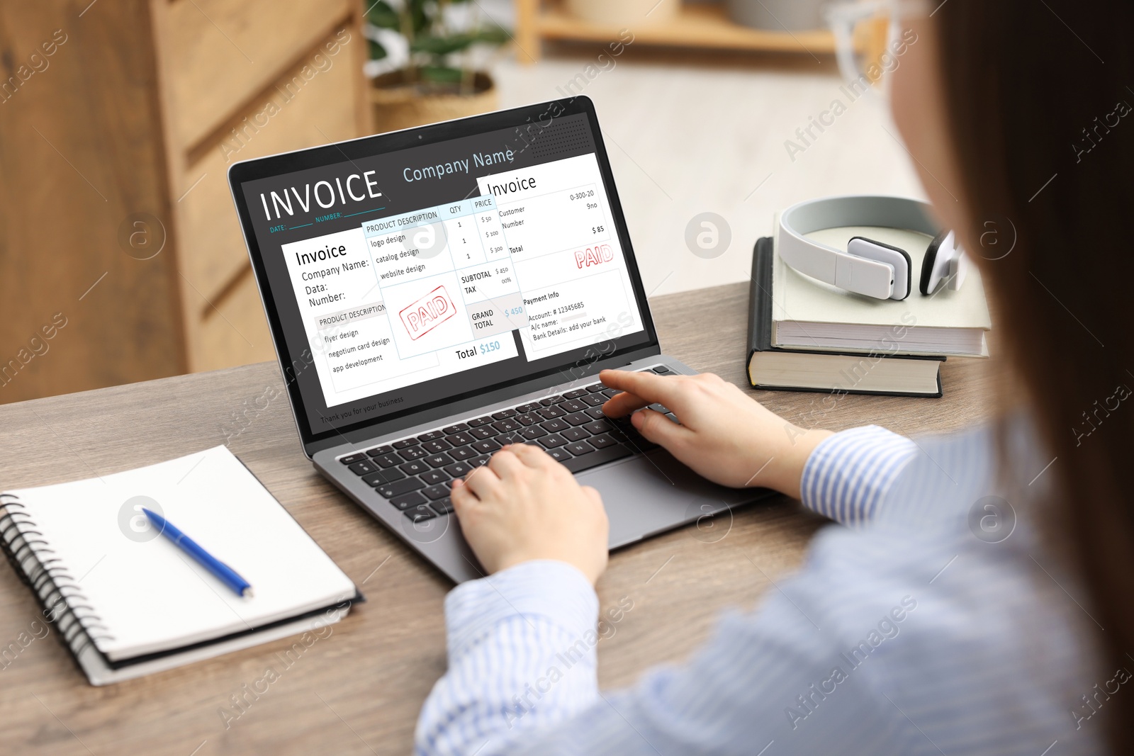 Image of Woman using laptop to pay bills at home, closeup