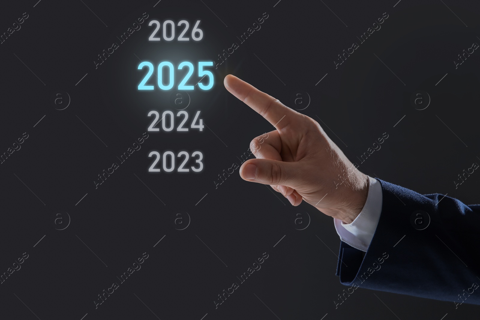 Image of New year goals. Businessman pointing at 2025 on virtual screen against black background, closeup