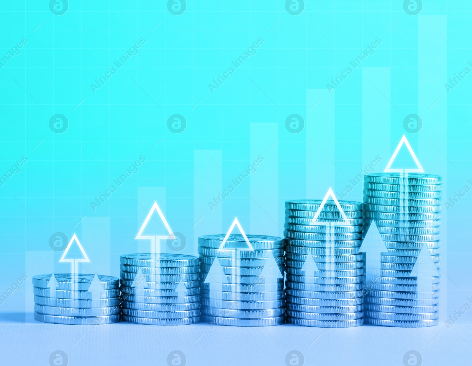 Image of Investment. Stacked coins with arrows on table, color toned