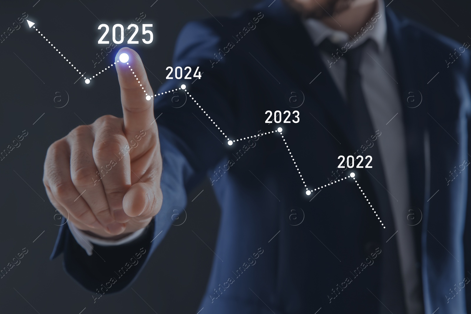 Image of New year goals. Businessman touching arrow with years points on virtual screen against black background, closeup