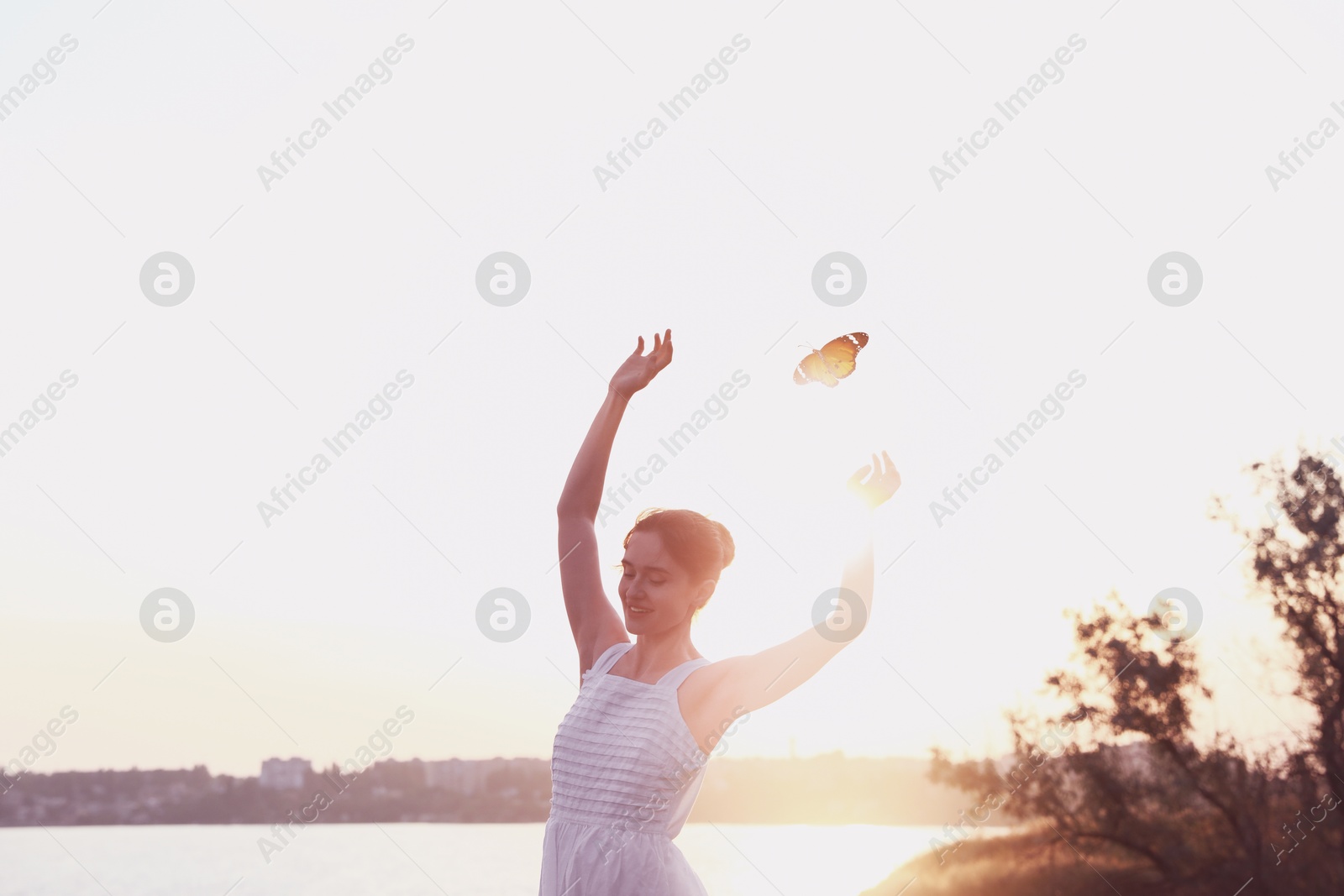 Image of Butterfly flying over dancing woman near river in morning. Beauty, health, spring, freedom